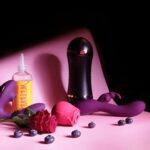 a pink bed with a bottle of mouthwash and a rose